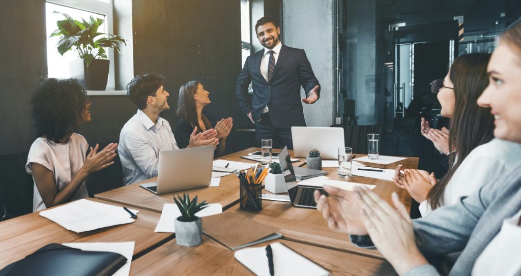 Business presentation. Group of businesspeople clapping hands