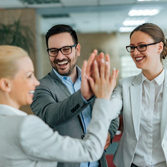 Motivated workers celebrating teamwork achievement. Business people high five, portrait.